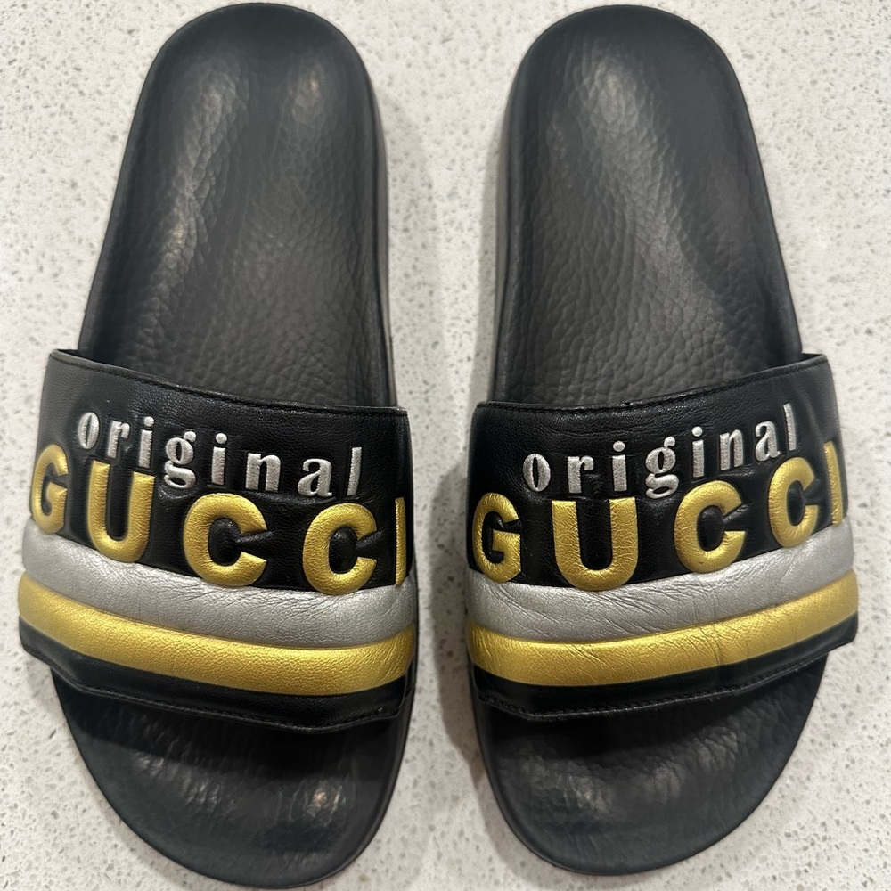 Authentic Gucci with Pursuit leather Black and Gold women’s Slides. Size 39 EU.
